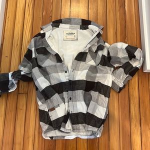 Never been worn, plaid long sleeve shirt. Has pockets
